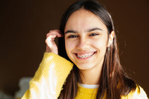 orthodontic braces on a smiling hispanic girl