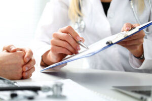 person filling out an insurance form to pay for braces
