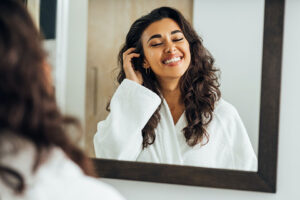 happy woman smiling in the mirror