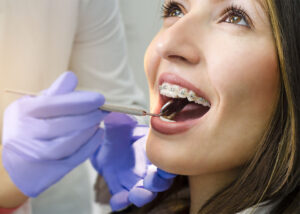 healthy woman with braces at orthodontic appointment