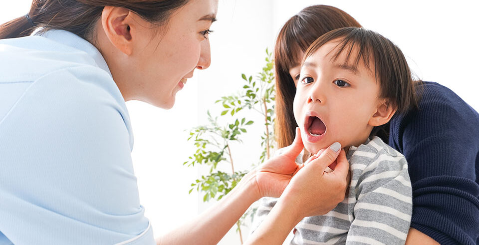 Mom looking for an underbite in her kid's mouth.